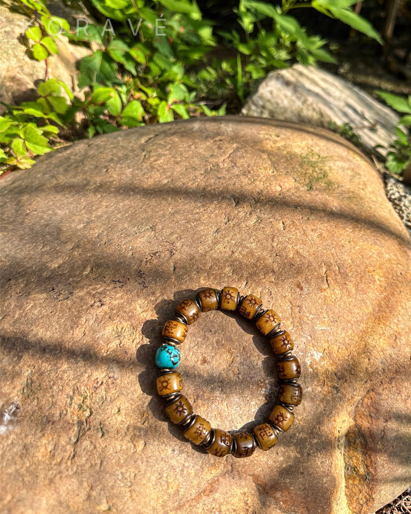 Yak bone bracelet in sunlight with Tibetan-inspired symbols of strength and protection