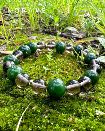 Green jasper and smoky quartz bracelet photographed in a natural landscape setting