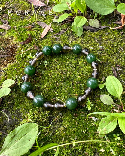 Green jasper and smoky quartz bracelet surrounded by earthy tones inspired by nature