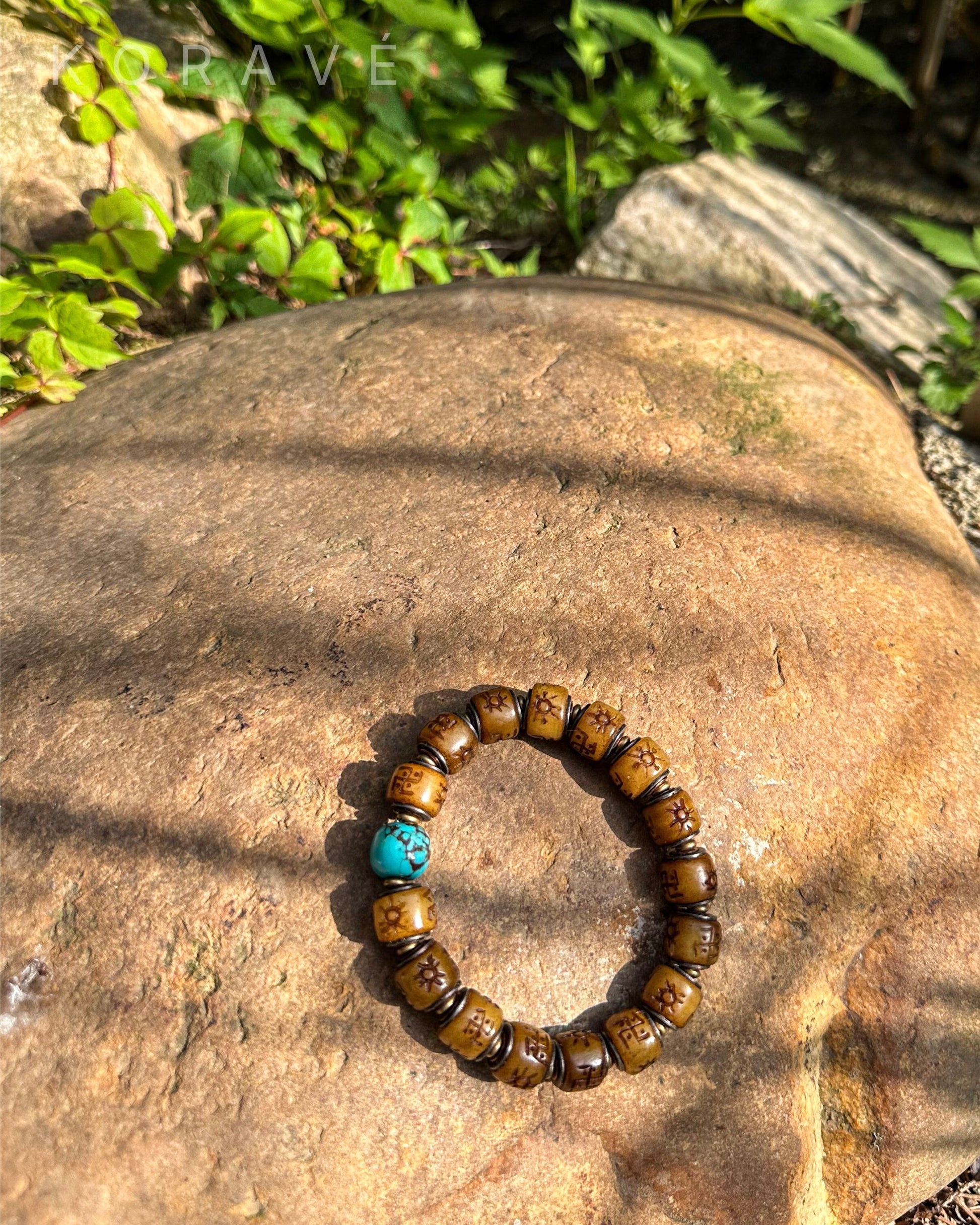 Yak bone bracelet in sunlight with Tibetan-inspired symbols of strength and protection